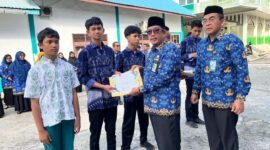 Kepala Kemenag Aceh Barat, H. Abrar ZYM, menyerahkan penghargaan kepada siswa madrasah peraih juara Olimpiade Sains Madrasah Aceh (OSMA) 2025 di Meulaboh.